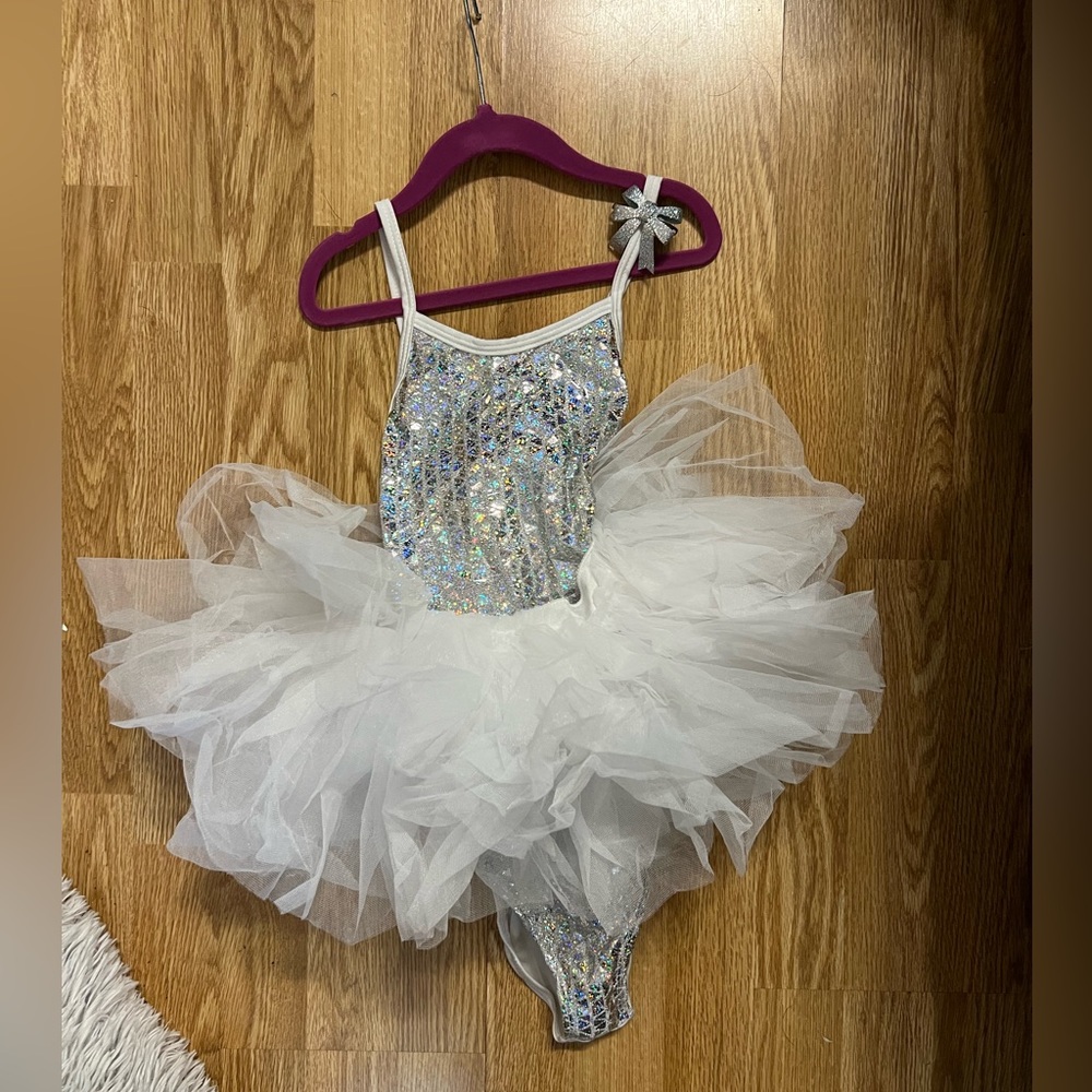 Hologram leotard with polyester tulle skirt. Barrette included medium child
